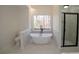 Modern bathroom featuring a soaking tub, glass shower, and a white vanity at 1190 Saint Ives Ct, Suwanee, GA 30024