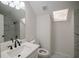 Bright bathroom with modern finishes including skylight and marble-look tile at 1190 Saint Ives Ct, Suwanee, GA 30024