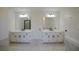 Bright bathroom featuring a double sink vanity, white cabinets, and black hardware at 1190 Saint Ives Ct, Suwanee, GA 30024