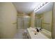 Well-lit bathroom with a shower-tub combo, single sink vanity, and decorative wallpaper at 1190 Saint Ives Ct, Suwanee, GA 30024
