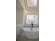 Bright bathroom showcasing a soaking tub, skylight, and marble accents at 1190 Saint Ives Ct, Suwanee, GA 30024
