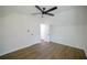 Bright bedroom featuring a ceiling fan, wood-look floors, and white walls at 1190 Saint Ives Ct, Suwanee, GA 30024