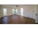 Well-lit bedroom features hardwood floors, white walls, and a ceiling fan at 1190 Saint Ives Ct, Suwanee, GA 30024