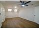 Well-lit bedroom featuring a ceiling fan, wood-look floors and skylights at 1190 Saint Ives Ct, Suwanee, GA 30024