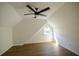 Bright bedroom features wood floors, ceiling fan, angled ceilings, and a window at 1190 Saint Ives Ct, Suwanee, GA 30024