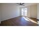 Bright bedroom with hard wood floors and natural light from the large windows at 1190 Saint Ives Ct, Suwanee, GA 30024