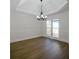 Dining room with hardwood floors, chair rail, tray ceiling, and large bright window at 1190 Saint Ives Ct, Suwanee, GA 30024