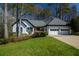 Attractive single-story home featuring a well-manicured lawn, mature landscaping, and a two-car garage at 1190 Saint Ives Ct, Suwanee, GA 30024