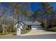 Charming ranch-style home with a two-car garage, well-maintained lawn, and mature trees at 1190 Saint Ives Ct, Suwanee, GA 30024