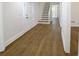 Warm foyer featuring wood-look flooring, a staircase, and a view into the house at 1190 Saint Ives Ct, Suwanee, GA 30024