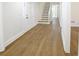 Inviting foyer with wood-look flooring leading to the staircase and a view into the house at 1190 Saint Ives Ct, Suwanee, GA 30024