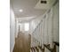 Bright hallway with beautiful wood floors and staircase with painted white railings at 1190 Saint Ives Ct, Suwanee, GA 30024