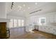 Open-concept kitchen with an island, white cabinets, stone fireplace and lots of windows at 1190 Saint Ives Ct, Suwanee, GA 30024