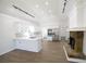 Bright kitchen with stone fireplace, stainless appliances, white cabinets and track lighting at 1190 Saint Ives Ct, Suwanee, GA 30024