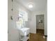 Charming laundry room with apron sink, white cabinets and hardwood floors at 1190 Saint Ives Ct, Suwanee, GA 30024