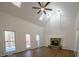 Bright living room with high ceilings, skylights, fireplace, ceiling fan, and hardwood flooring at 1190 Saint Ives Ct, Suwanee, GA 30024