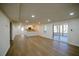 Spacious living area with wood-look flooring, leading to a screened-in porch and an open kitchen at 1190 Saint Ives Ct, Suwanee, GA 30024