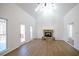 Spacious living room with vaulted ceilings, a stone fireplace, access to the deck, and hardwood floors at 1190 Saint Ives Ct, Suwanee, GA 30024