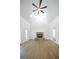 Open-concept living room with a vaulted ceiling, stone fireplace, and expansive hardwood flooring at 1190 Saint Ives Ct, Suwanee, GA 30024