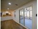 Bright living room open to kitchen with hardwood floors and a sliding glass door to a screened-in porch at 1190 Saint Ives Ct, Suwanee, GA 30024