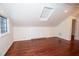 Attic space featuring wood floors, built-in cabinets, ample lighting, and unique architectural features at 1251 Cumberland Ne Rd, Atlanta, GA 30306