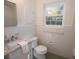 Bright bathroom featuring a marble vanity, white tile walls, and a window at 1251 Cumberland Ne Rd, Atlanta, GA 30306
