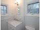 Bright bathroom featuring a vanity with marble countertop, undermount sink, and two windows at 1251 Cumberland Ne Rd, Atlanta, GA 30306