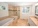 Bright bathroom with a glass-enclosed shower, soaking tub, tile surround, and double sink vanity at 1251 Cumberland Ne Rd, Atlanta, GA 30306