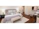 A well-furnished bedroom with a queen-sized bed, sitting chair, and hardwood floors at 1251 Cumberland Ne Rd, Atlanta, GA 30306