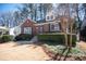 Charming brick home showcasing a manicured lawn and mature trees at 1251 Cumberland Ne Rd, Atlanta, GA 30306