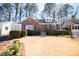 Charming brick home featuring a manicured lawn and lovely landscaping at 1251 Cumberland Ne Rd, Atlanta, GA 30306