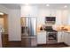 Bright kitchen, with a stainless-steel refrigerator, granite countertops, and white cabinets at 1251 Cumberland Ne Rd, Atlanta, GA 30306