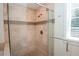 Modern shower with glass door, rain shower head, tile surround, and built-in seat at 1251 Cumberland Ne Rd, Atlanta, GA 30306