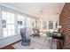 Beautiful sun room with white ceiling and walls of windows with brick accent wall at 1251 Cumberland Ne Rd, Atlanta, GA 30306