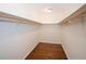 An empty walk-in closet features hardwood floors and wooden rods at 1251 Cumberland Ne Rd, Atlanta, GA 30306
