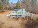 Rear exterior featuring an expansive deck perfect for outdoor entertaining and relaxation at 241 Nacoochee Dr, Woodstock, GA 30188