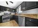 Kitchen featuring stainless steel appliances, dark cabinetry and granite countertops at 3730 N Quail Dr, Douglasville, GA 30135