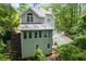Back of home with large windows, set in a green environment with a long driveway at 2690 Valvedere Dr, Brookhaven, GA 30319