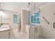 Modern bathroom with glass-enclosed shower, double sink vanity, and natural light at 2690 Valvedere Dr, Brookhaven, GA 30319