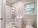 Bathroom with a walk-in shower, white vanity, and a window providing natural light at 2690 Valvedere Dr, Brookhaven, GA 30319