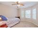 This bedroom has natural light from the windows, carpeted floors and a ceiling fan at 2690 Valvedere Dr, Brookhaven, GA 30319