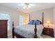 Cozy bedroom features a four-poster bed with a floral patterned duvet, and a bedside table with a lamp at 2690 Valvedere Dr, Brookhaven, GA 30319