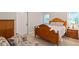 This bedroom features a wooden bed frame, side table with a lamp, and a comfortable sitting chair at 2690 Valvedere Dr, Brookhaven, GA 30319