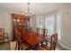 Classic dining room with a large table, elegant china cabinet, chandelier, and natural light at 2690 Valvedere Dr, Brookhaven, GA 30319