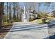 Traditional home with a long driveway, a two-car garage, mature trees, and manicured landscaping at 2690 Valvedere Dr, Brookhaven, GA 30319