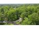 An exterior image of a home surrounded by lush greenery, with a curved driveway at 2690 Valvedere Dr, Brookhaven, GA 30319