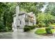 Beautiful two-story home with a large front yard, a two-car garage, and mature trees at 2690 Valvedere Dr, Brookhaven, GA 30319