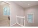 Bright upper hallway with natural light from large arched window at the end of hall at 2690 Valvedere Dr, Brookhaven, GA 30319