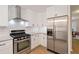 Modern kitchen with stainless steel appliances, gas range, and white subway tile backsplash at 2690 Valvedere Dr, Brookhaven, GA 30319