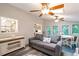 Relaxing living room with ceiling fans, multiple windows, and comfortable seating near the kitchen area at 2690 Valvedere Dr, Brookhaven, GA 30319
